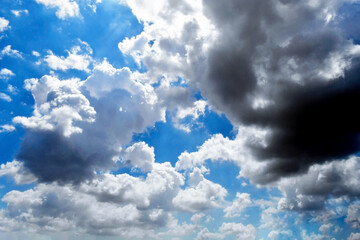 Dramatic dark cloud in sunny day cumulus white clouds with blue sky. Cloudscape summer tropical background.