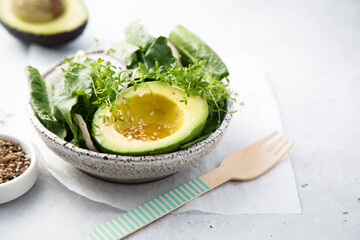Avocado salad with microgreens and red onion