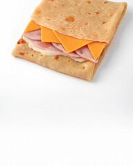 Fast food: pancake with ham, cheese and cheese sauce on white background. Serving for bar, menu.
