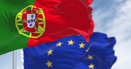 Close-up of Portugal and the European Union flags waving on a clear day - Powered by Adobe