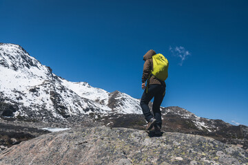 Hiking woman hiker climbing to  the mountain top