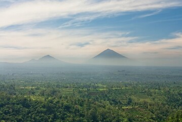 Mount Agung presides over terraces of green paddy fields in Bali, Indonesia