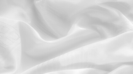 white fabric with a subtle pattern delicately captured in the folds. The fabric reflects light, creating a smooth, satiny appearance. Its texture appears silky,