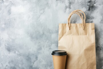 Recycled paper bag mockup and coffee to go cup, front view, grey background. Brown take away cup with black lid, kraft shopping package. Food takeaway, eco-friendly packaging concept. Branding mock up