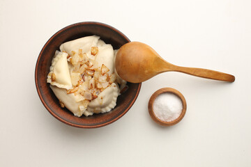 Traditional Ukrian food dumplings and sour cream Pierogi or pyrohy, varenyky, vareniki, dumplings served with caramelized salted onion in bowl