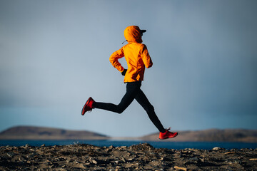 Female runner running at the winter high altitude lakeside, Tibet