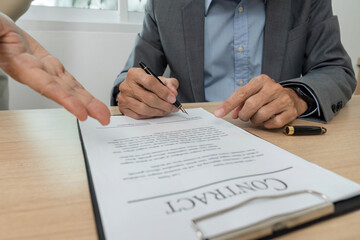 Contract Signing and Agreement. Close-up of a businessman signing a contract in a professional...