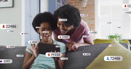 Teenage girl tapping tablet initiating social media stream while mother leaning in alerts rising - Powered by Adobe