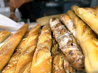 A pile of freshly baked baguette bread produce on the bread shop. Basque Country.