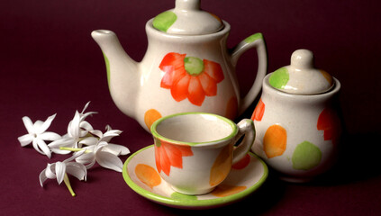 Indian masala chai or tea in cup, with kettle, spices and tea leaves on dark, wooden background. cafe, retro, restaurant, vintage, ethnic, healthy, hotel concepts.