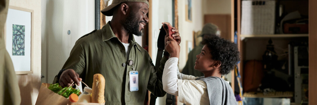 Black Man Delivering Groceries and Sharing a Joyful Moment with Son Header