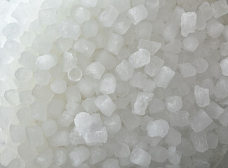 White background with a pile of small ice cubes top