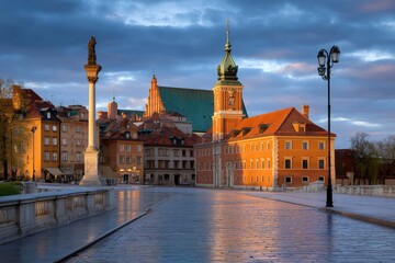 Fototapeta premium European city square glows with warm light as dawn breaks, highlighting architecture and stone