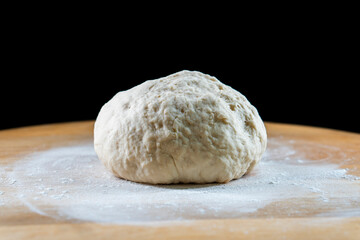 yeast dough on a wooden board. Fresh baked goods. Food. Bread. The concept of food