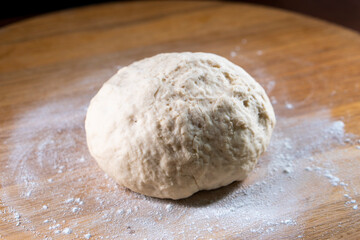 yeast dough on a wooden board. Fresh baked goods. Food. Bread. The concept of food