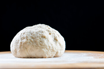 yeast dough on a wooden board. Fresh baked goods. Food. Bread. The concept of food