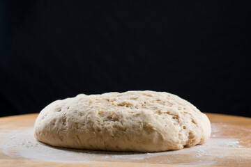 yeast dough on a wooden board. Fresh baked goods. Food. Bread. The concept of food