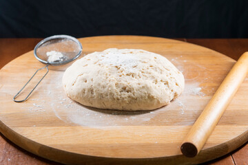 yeast dough on a wooden board. Fresh baked goods. Food. Bread. The concept of food