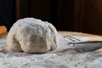 yeast dough on a wooden board. Fresh baked goods. Food. Bread. The concept of food