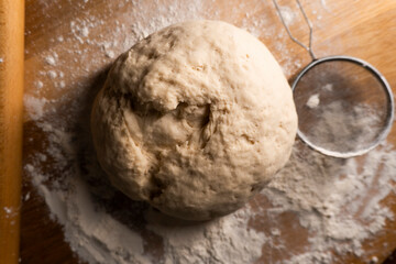yeast dough on a wooden board. Fresh baked goods. Food. Bread. The concept of food
