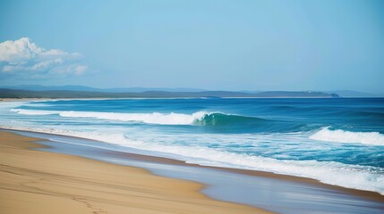 Stunning sandy beach with gentle soft blue ocean waves rolling onto the shore, creating a serene and picturesque coastal scene