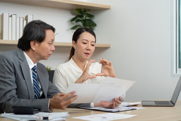 Strategic Financial Consultation. Professionals engaged in a discussion about financial planning in an office.