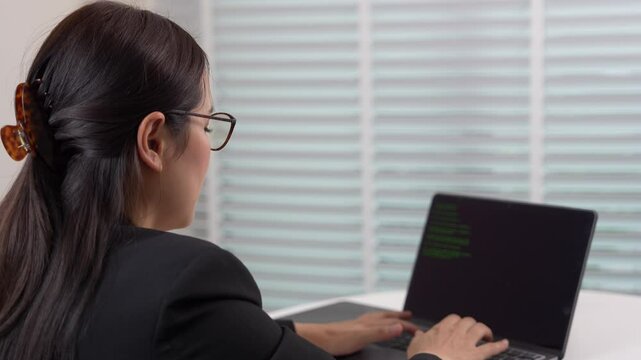 Woman in Tech Coding on Screen