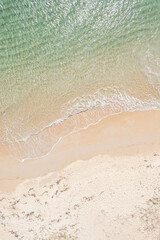 drone top down view shot capturing the serene beauty of a tropical coastline with gentle waves