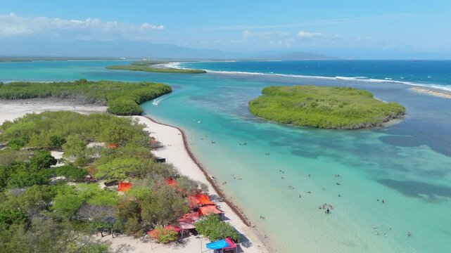 People Swim In Turquoise Blue Water Of Playa Caobita In Summer In Azua, Dominican Republic. - aerial shot