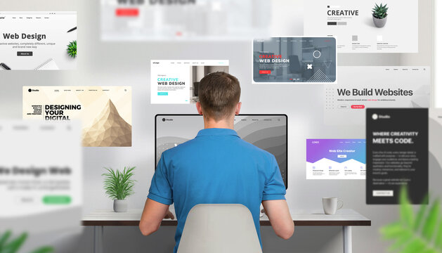 Back view of a web designer working at a desk, focused on a computer screen while numerous website layouts fly forward around him. Powerful visual of creative productivity and digital content creation - Powered by Adobe