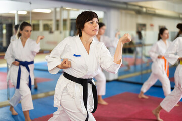 Woman at a group self-defense training. European woman practicing card technique on her opponent