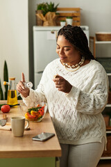Cooking a fresh salad in a cozy kitchen setting during a sunny afternoon
