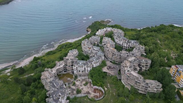 Top-down aerial view of abandoned hotel complex in Tsarevo, Bulgaria. Surreal architecture overtaken by nature. Urbex hotspot with unique structure, decay, and post-apocalyptic atmosphere