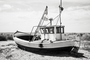 The fishing boats stand quietly on the coastline