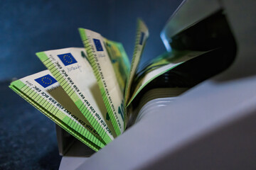 100 Euro banknotes beeing counted in a banknote counting machine