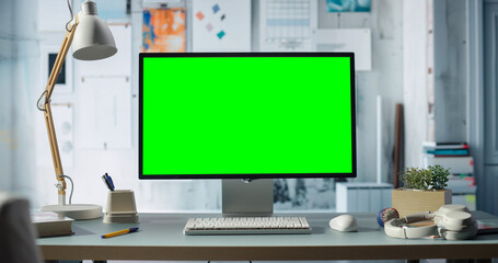 Desktop Computer With Green Chroma key Screen Is on Desk in Modern Home Office, Creative Projects or Engineering Project, Essential Tech Accessories