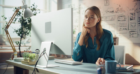 Portrait of Smiling WHite Female Professional Working on Computer. Sunlit Office With Whiteboard...