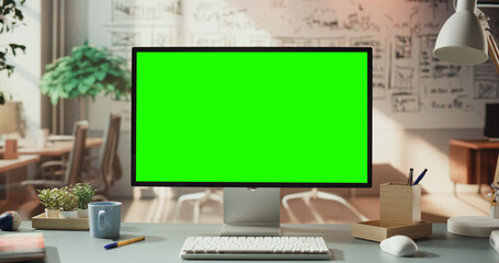 Green Screen Monitor in Cozy Home Office Setup. Chroma key Display for Digital Content Creation....