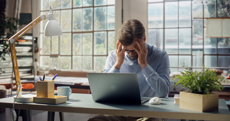 Professional Displays Signs of Stress While Working on Laptop. Visual Metaphor for Workplace Pressure, Modern Struggle Between Productivity Demands and Mental Well-being in Today's Environment.