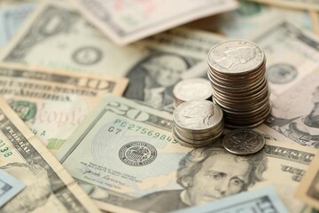 American US dollars money bills with coins and constitution close up on american flag