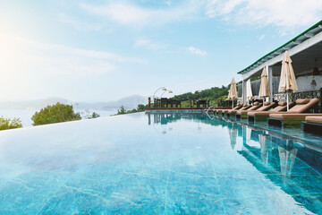 Hotel Infinity Pool and Sun Loungers in Summer