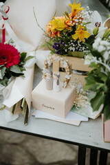 Close-Up of Wedding Decor with Handmade Bride and Groom Figurines on Wooden Gift Box