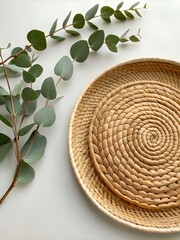 Natural Woven Baskets and Eucalyptus Branch on White Background, Eco-Friendly Home Decor with Organic Textures and Minimalist Aesthetic for Sustainable Living