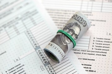 Bangladeshi taka money bills in big amount lies on table with tax forms close up