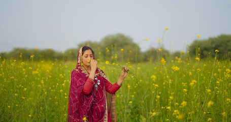 Indian happy adult gen x beautiful model woman lady wear red traditional saree enjoy outdoor nature...