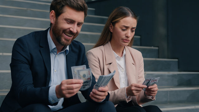 Caucasian colleagues man woman count money salary business financial inequality envy offended female girl worker with laughing happy male manager rivalry jealousy cash bills discrimination in city
