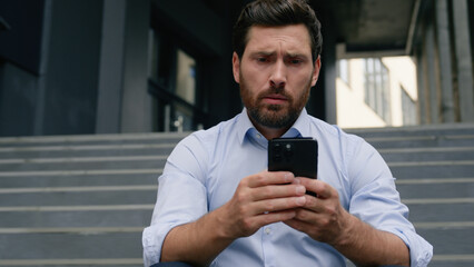 Stressed unemployed fired business man with dismissal box chatting phone searching new job online service dismiss businessman upset in city financial crisis holding smartphone near office building