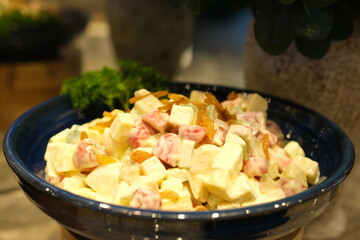 Healthy homemade russian traditional salad olivier ready to eat, close up. Rotates plate with salad olivier