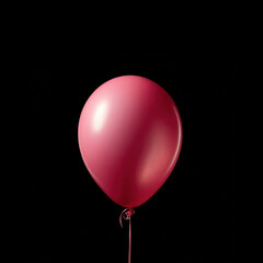 Pink balloon against black backdrop