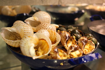 Seafood charcuterie platter board with shrimp, oysters, fish and octopus on black background. Top view, close up. High quality